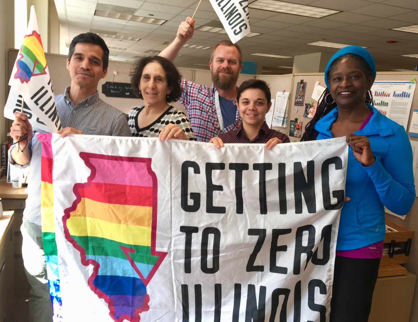 Picture of 5 people who work at Chicago Department of Public Health holding up Getting to Zero Illinois rainbow flags.